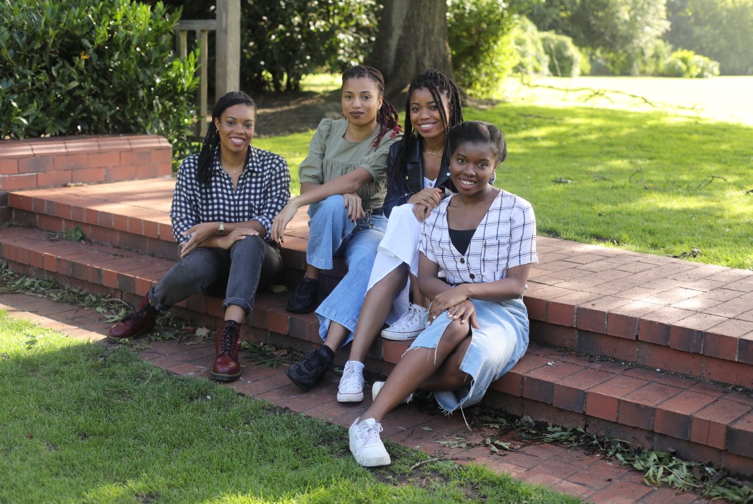 Photo of 4 sisters sitting outside